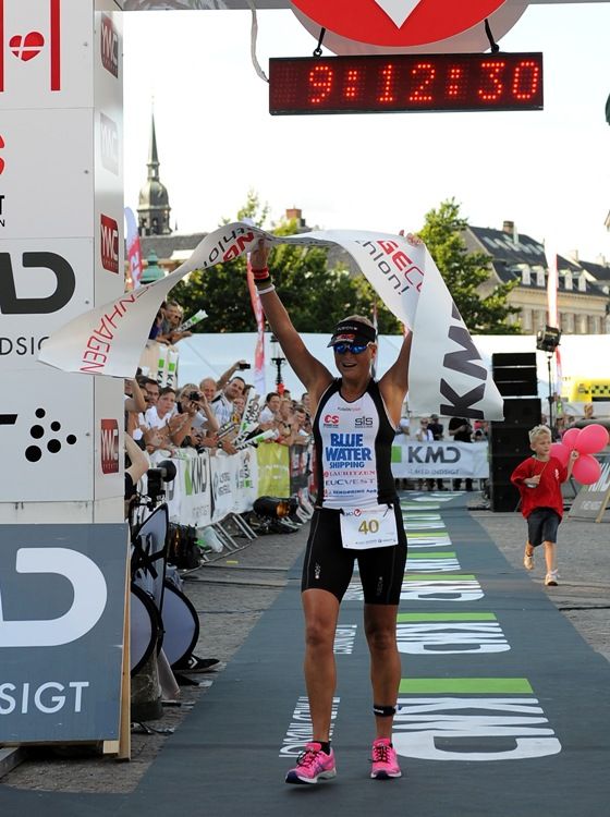 COPENHAGEN, DENMARK - AUGUST 12: Camilla Pedersen crosses the finish line to win the women's iron distance triathlon KMD Challenge Copenhagen 2012 on August 12, 2012 in Copenhagen, Denmark. (Photo by Chris Brunskill/Getty Images) *** Local Caption *** Camilla Pedersen