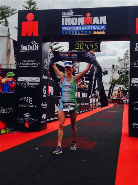 An elated Elizabeth Lyles raising the banner over the line. Photo: IronmanLive / Delly Carr